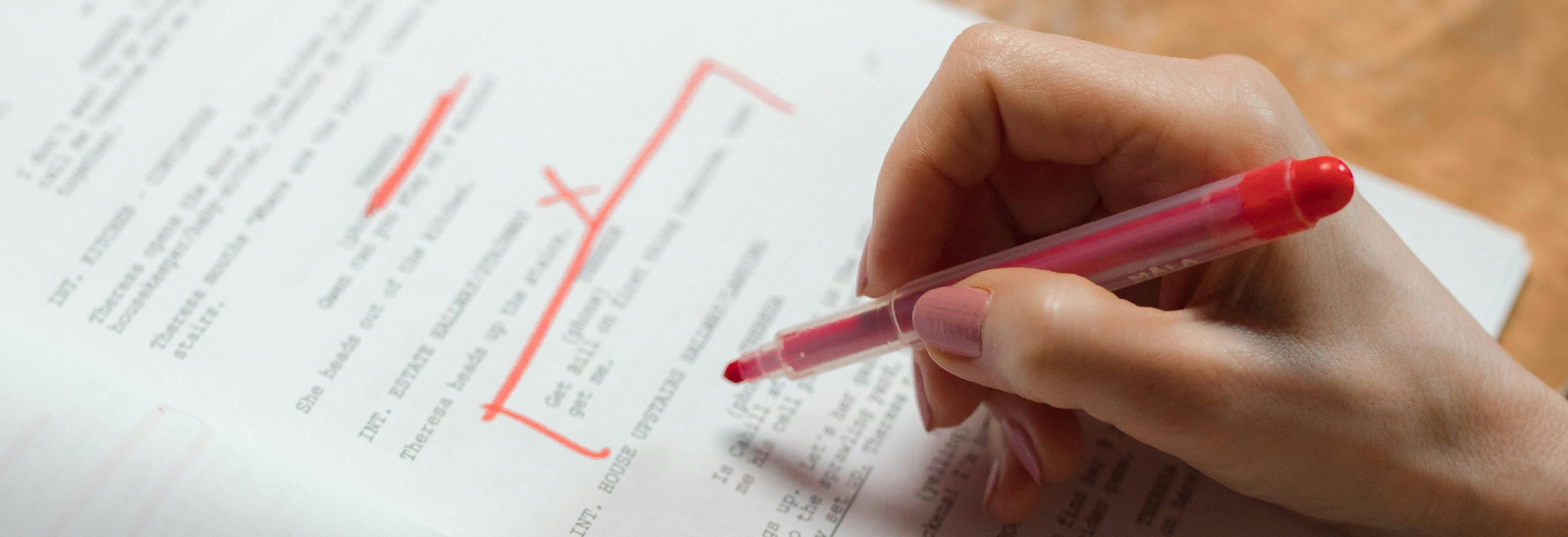 Proofreading with Red Pen in Hand